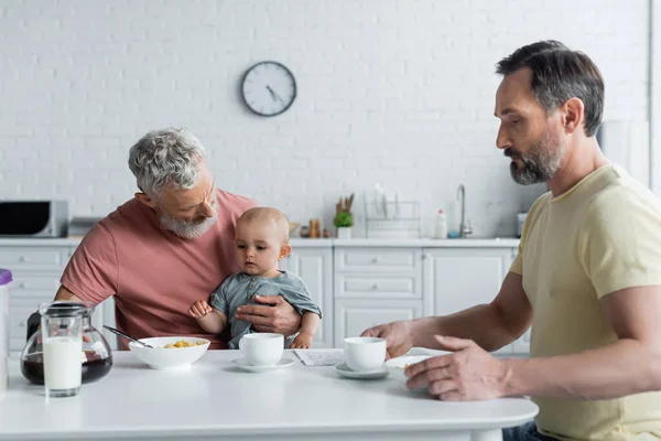 Homosexual Couple Baby Daughter Sitting Breakfast Kitchen — Stock Photo, Image