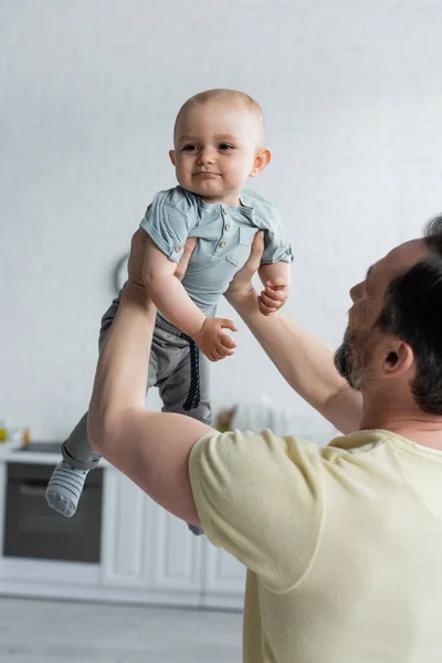 Mature Man Holding Baby Girl Home — Stock Photo, Image