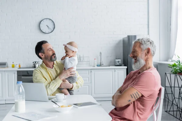 Homosexual Freelancer Holding Baby Daughter Cheerful Partner Kitchen — Stock Photo, Image