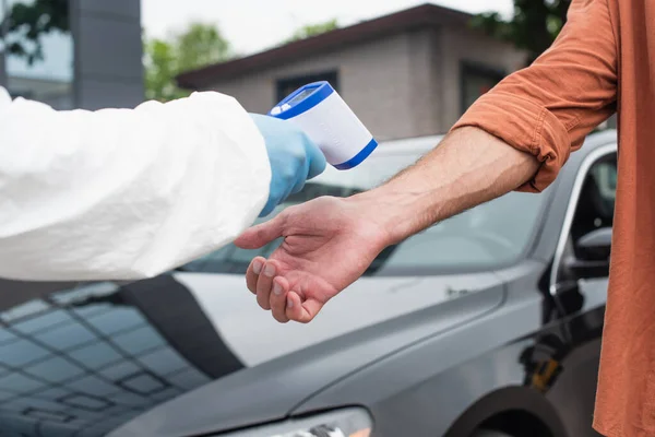 Cropped View Medical Worker Holding Pyrometer Driver Car — Stock Photo, Image