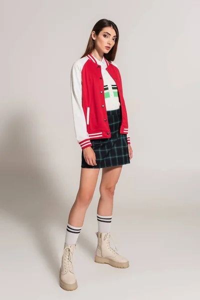 Young Woman Stylish Jacket Plaid Skirt High Boots Posing Grey — Foto de Stock