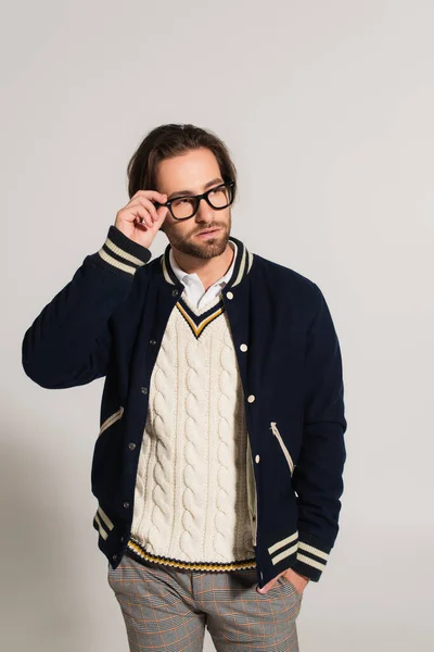 Man Blue Jacket Adjusting Eyeglasses While Standing Hand Pocket Grey — Stockfoto