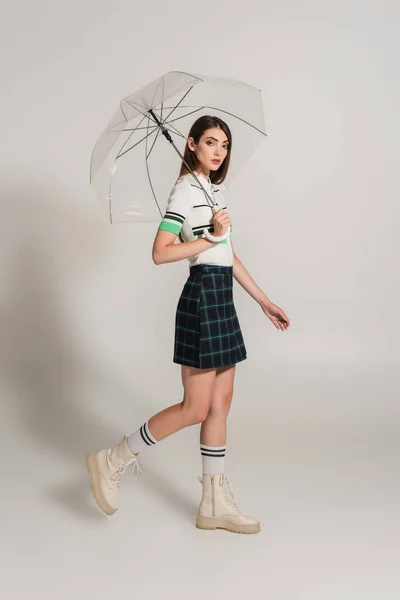 Young Woman Stylish Clothes Walking Transparent Umbrella Grey Background — Foto de Stock