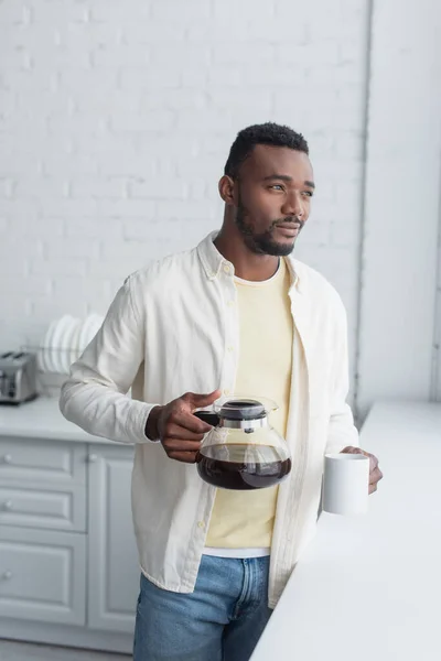 Young African American Man Holding Coffee Pot Mug Kitchen — Stock Photo, Image