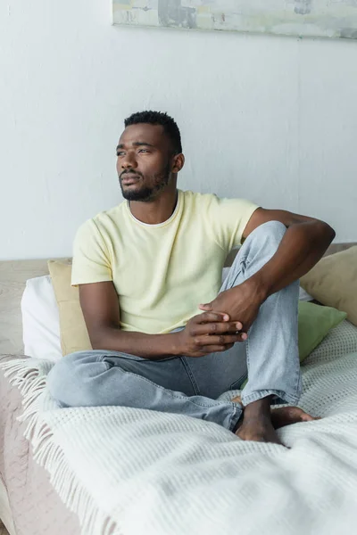 Barefoot African American Man Looking Away While Thinking Sitting Bed — Stock Photo, Image
