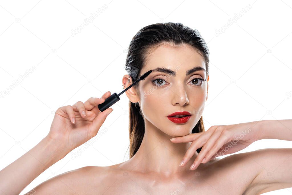 young woman holding mascara brush isolated on white 