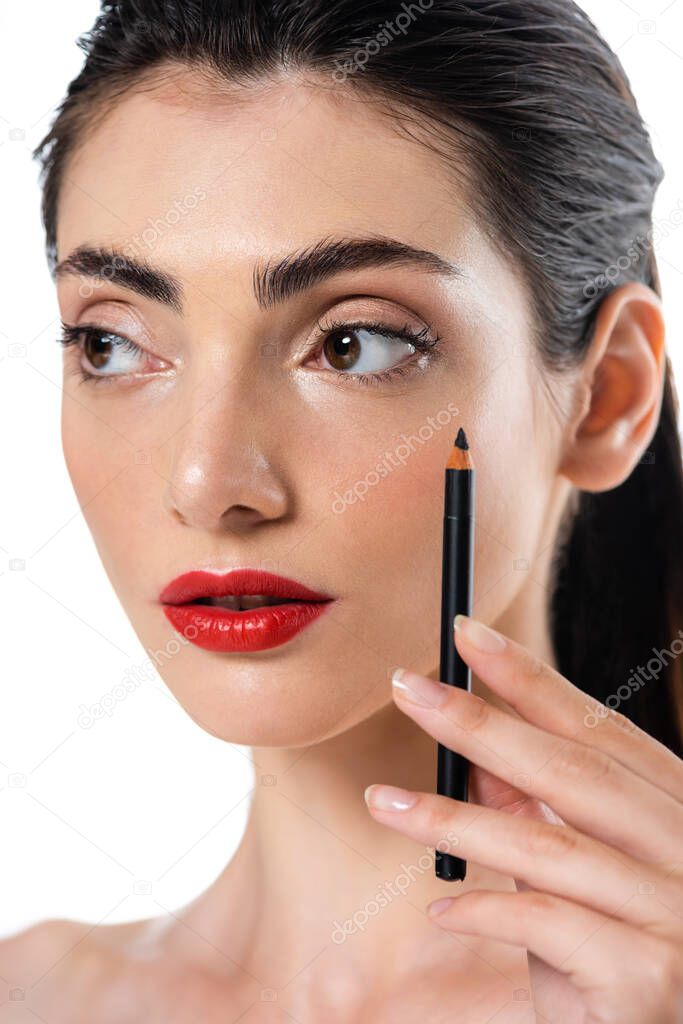 young woman with red lips holding eye pencil isolated on white 