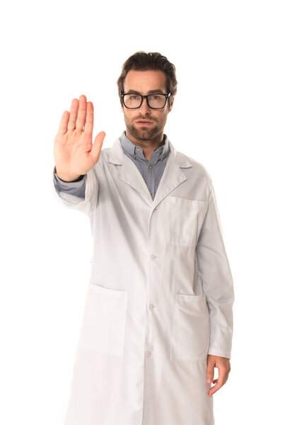 Young doctor showing stop gesture isolated on white 