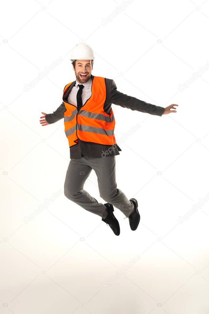 Happy engineer jumping isolated on white 