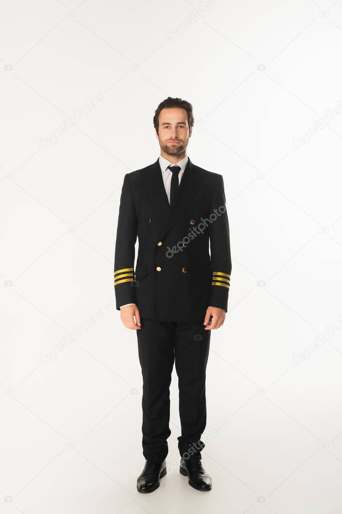Young pilot looking at camera on white background 