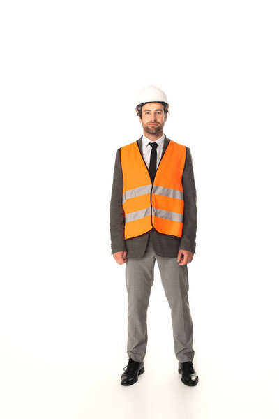 Full length of engineer in safety vest looking at camera on white background 
