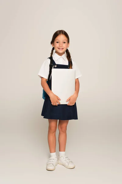 Cheerful Schoolgirl Looking Camera While Standing Laptop Grey — Stock Photo, Image