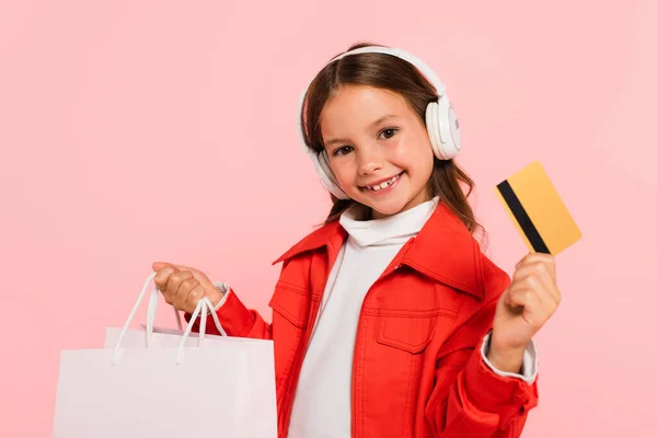 Cheerful Girl Headphones Holding Credit Card Shopping Bag Isolated Pink — Stock Photo, Image