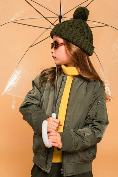 Girl Trendy Jacket Knitted Hat Sunglasses Standing Umbrella Isolated Beige — Stock Photo, Image