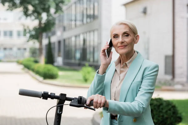 Elderly Businesswoman Talking Mobile Phone Electric Kick Scooter Outdoors — Stock Photo, Image