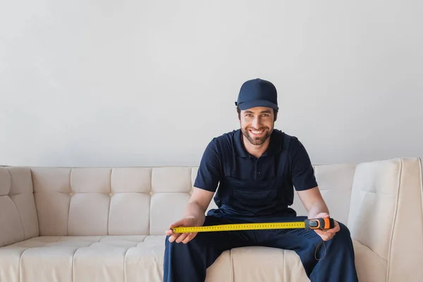 Happy Worker Looking Camera While Sitting White Sofa Measuring Tape — Stock Photo, Image