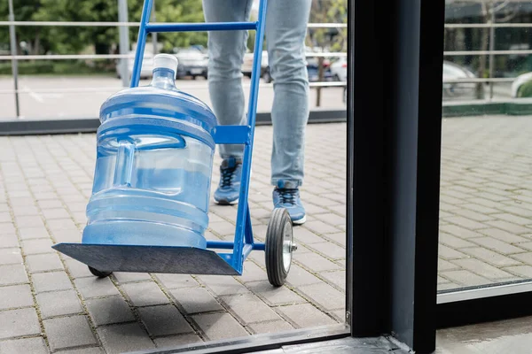 Cropped View Courier Standing Bottle Water Cart — Stock Photo, Image