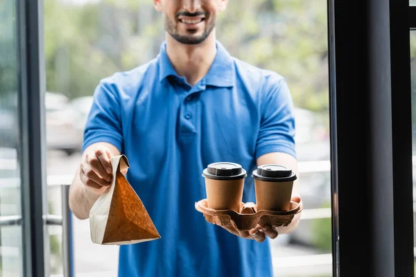Cropped View Coffee Paper Bag Hands Blurred Courier — Stock Photo, Image