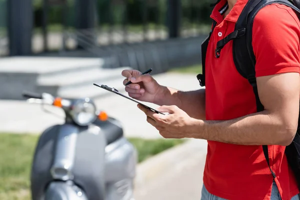 Cropped View Courier Holding Pen Clipboard Blurred Scooter — Stock Photo, Image
