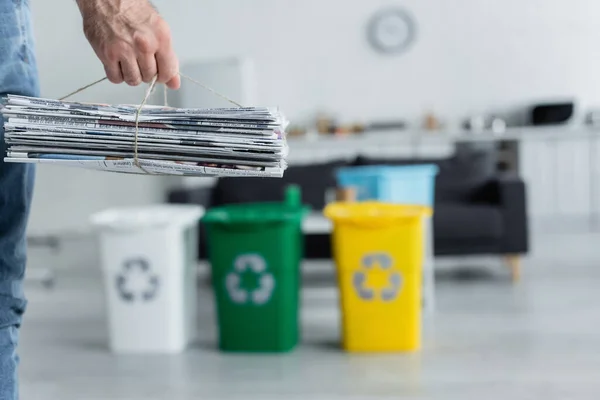 Cropped View Man Holding Newspapers Blurred Trash Cans Recycle Sign — Stock Photo, Image