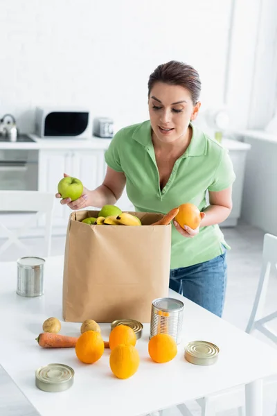 Mulher Segurando Frutas Perto Saco Papel Cozinha — Fotografia de Stock