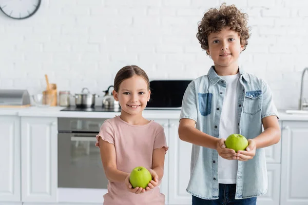 Positive Brother Sister Holding Apples Kitchen — Stock Photo, Image