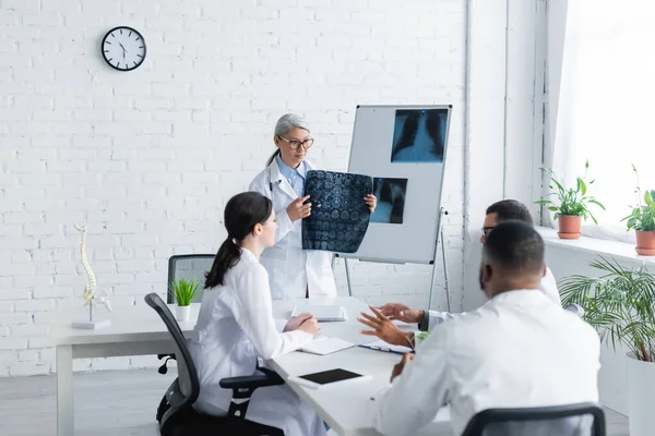 Middle Aged Asian Doctor Holding Head Mri Scan Multiethnic Physicians — Stock Photo, Image