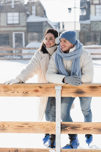 Happy Young Woman Ear Muffs Cheerful Man Winter Hat Leaning — Stock Photo, Image