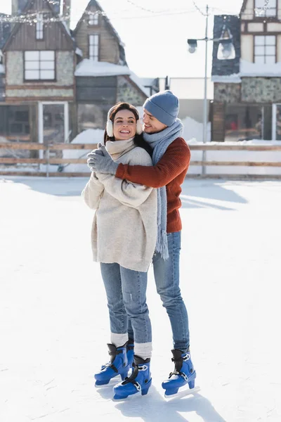 Voller Länge Glücklicher Mann Umarmt Junge Frau Ohrenschützer Auf Eisbahn — Stockfoto