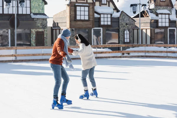 Full Length Young Woman Ear Muffs Holding Hands Boyfriend While — Stock Photo, Image