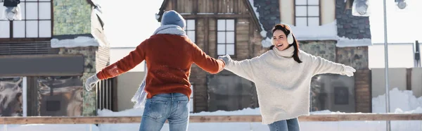 Positive Young Woman Ear Muffs Holding Hands Boyfriend Ice Rink — Stock Photo, Image