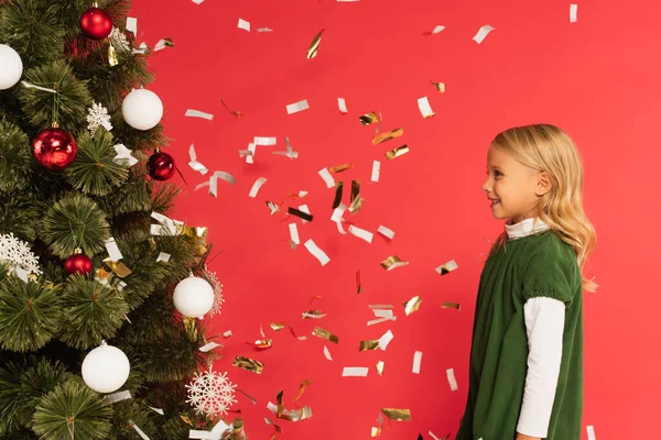 Side View Happy Girl Green Dress Christmas Tree Falling Confetti — Stock Photo, Image