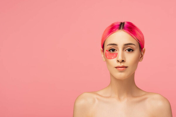 young woman with colorful hair and moisturizing eye patch isolated on pink 
