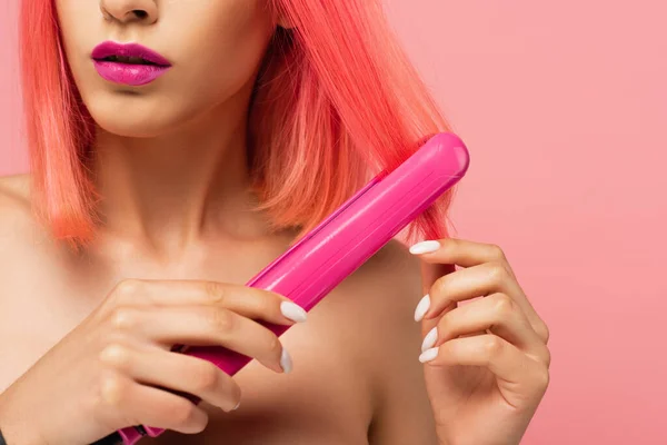 用粉色孤立的头发矫直机剪下的彩色头发的年轻女子的剪影 — 图库照片