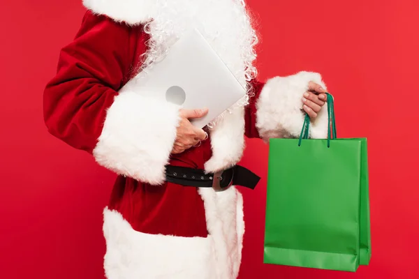 Cropped View Santa Claus Holding Shopping Bags Laptop Isolated Red — Stock Photo, Image