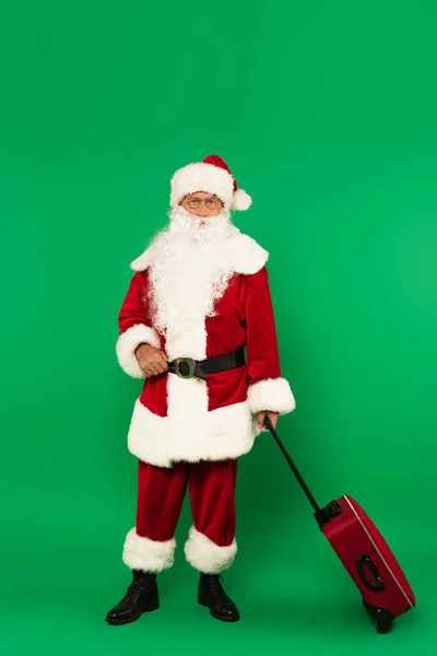 Santa Claus Costume Holding Suitcase Green Background — Stock Photo, Image