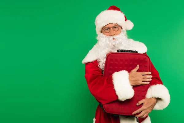 Santa Claus Sombrero Gafas Abrazando Maleta Aislada Verde — Foto de Stock