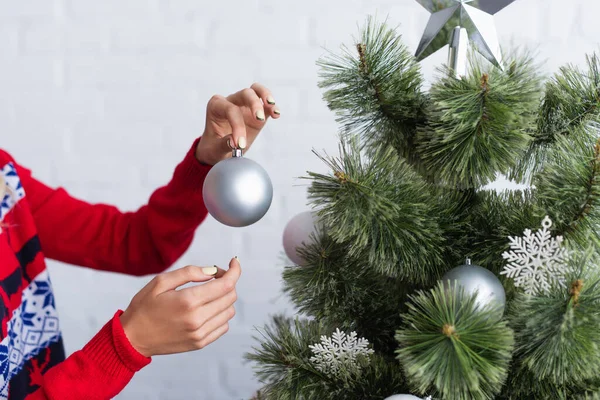 Cropped View Woman Holding Shiny Christmas Ball While Decorating Pine — Stock Photo, Image