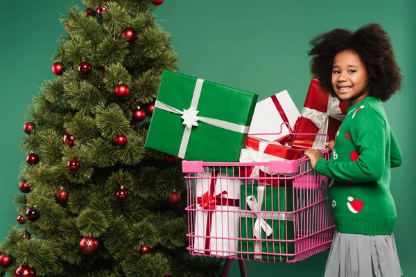 Positive African American Kid Standing Shopping Cart Presents Christmas Tree — Stock Photo, Image