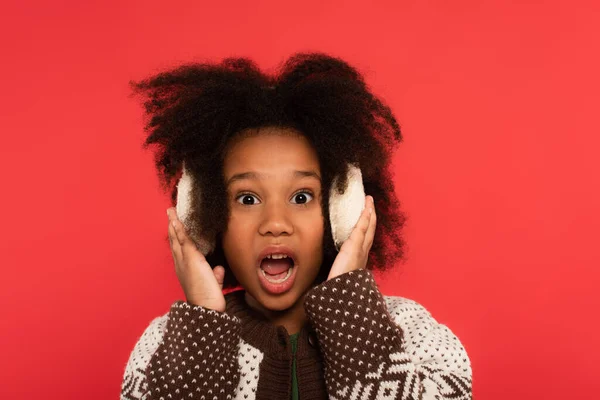 Amazed African American Kid Ear Muffs Looking Camera Isolated Red — Stock Photo, Image