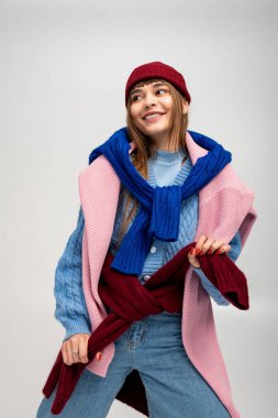 Genç kadın neşeli bir şekilde poz veriyor, şık bir şekilde, neşeli ruhunu sergiliyor..