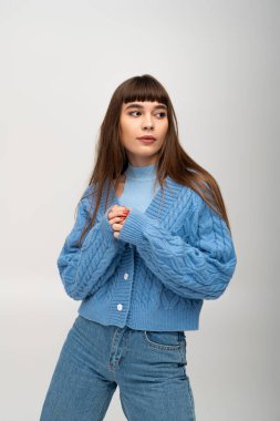 Güzel, genç bir kadın sıcak ve enerjik bir sonbahar modasında aktif olarak poz veriyor..