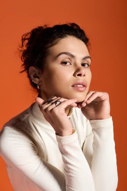 Stylish young woman poses confidently, showcasing her modern fashion sense.