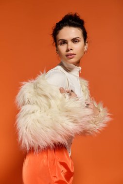 A beautiful young woman poses confidently in a striking outfit, highlighting her fashion sense.