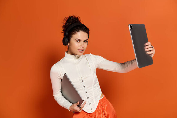 Festive atmosphere as a beautiful woman dresses fashionably, engaging with tech and music.