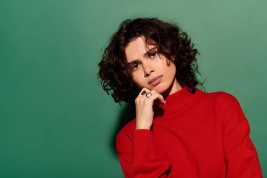 Charming young woman showcases her stylish personality with a striking red sweater and curly hair.