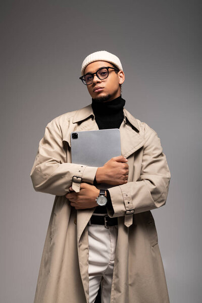 A stylish young man blends classic and contemporary fashion with elegance.