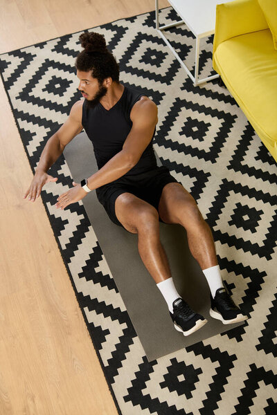 Атлетичный афроамериканец с вьющимися волосами тренируется дома, фокусируясь на физических упражнениях и фитнесе.