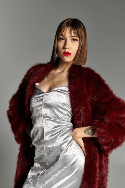 In a chic outfit, a young woman radiates beauty and poise, capturing a stunning moment.