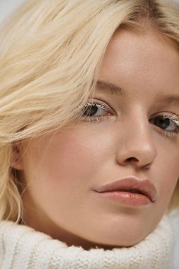 Beyaz kirpikli güzel bir kadın zarif bir poz verir, kışın güzelliğini gösterir..